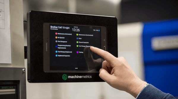 Hand Reaching Out to Touch a MachineMetrics Tablet