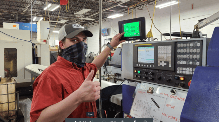 A Quality Manager Giving a Thumb's Up Near a CNC Machine