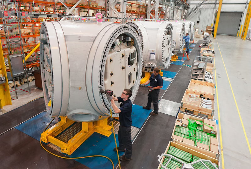 Technicians Working on Large Equipment in Factory