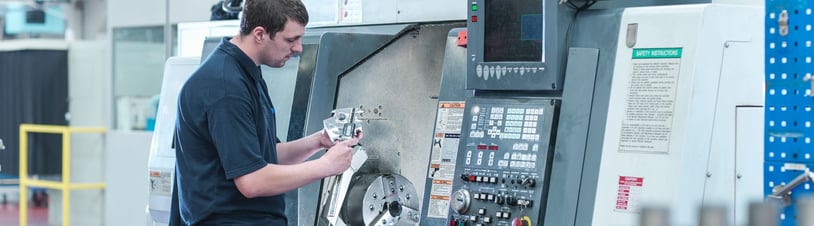 Technician Working at a CNC Machine.