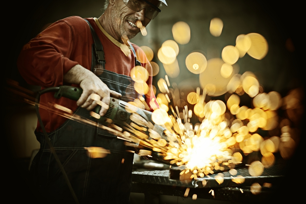 Industrial Worker Cutting and Welding Metal